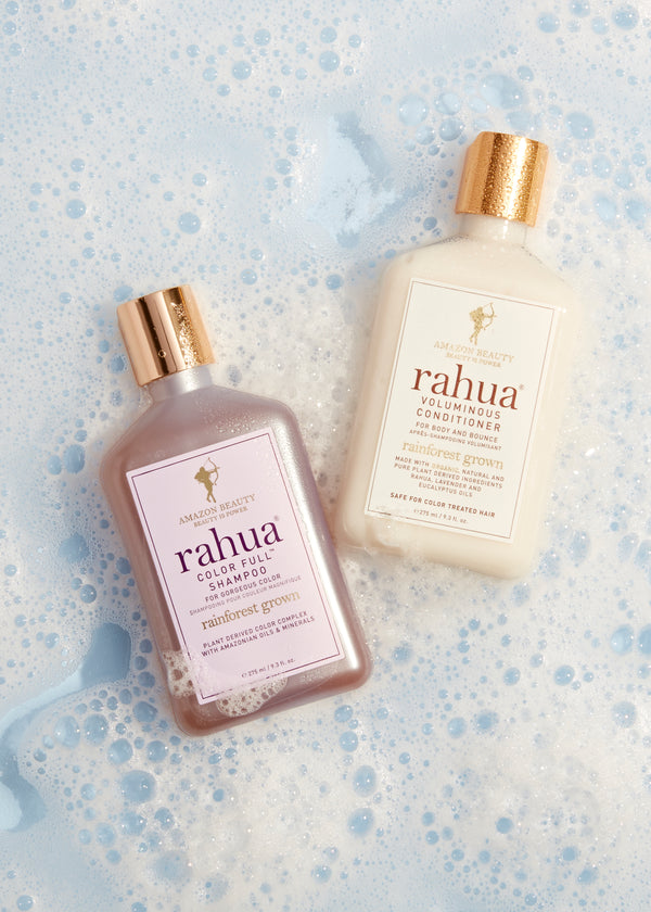 Rahua color full shampoo and voluminous conditioner on the floor with foam