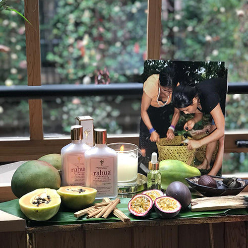 Rahua products with natural ingredients used in them placed by a window along with rahua rainforest community image