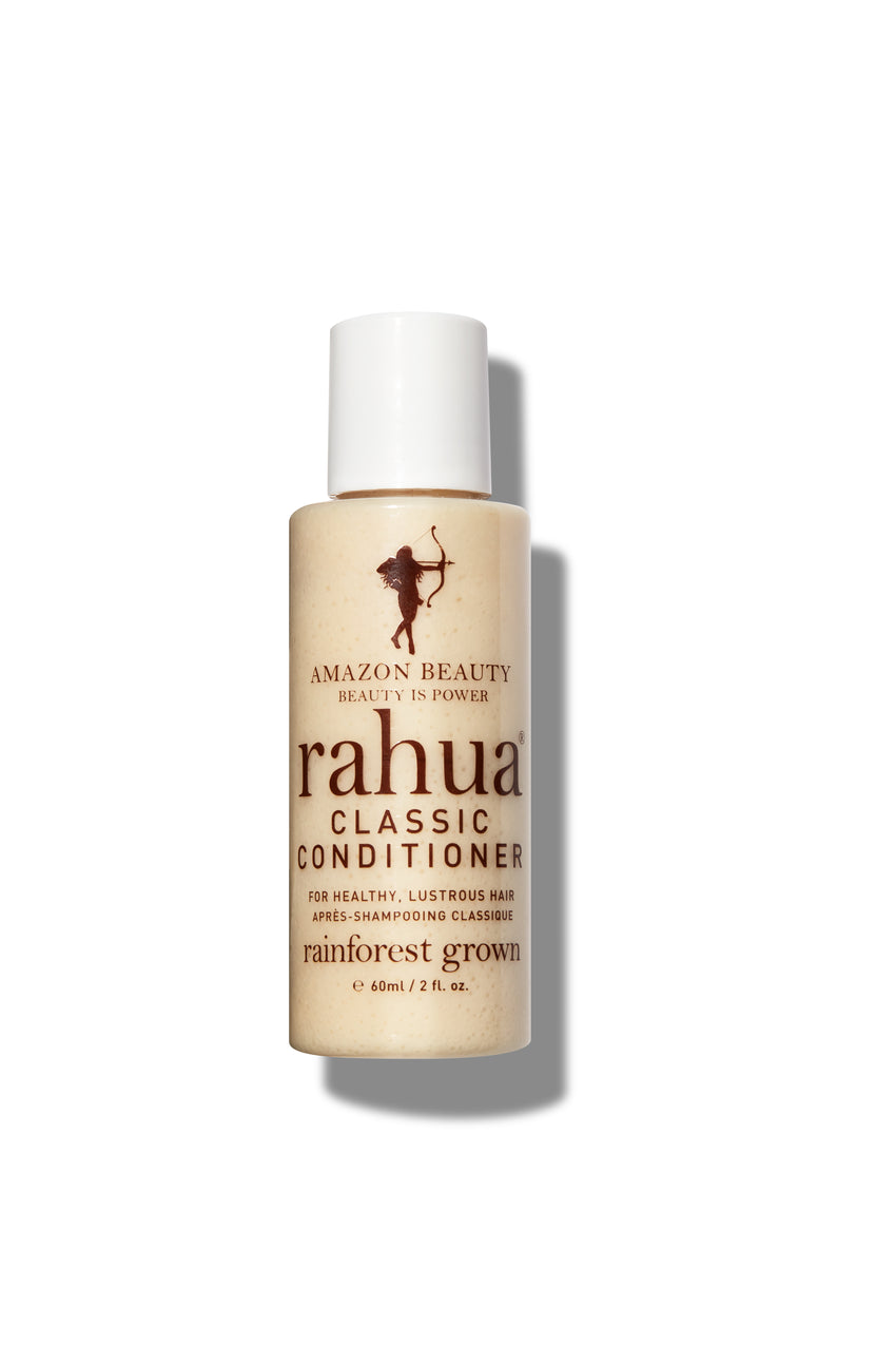 2 oz bottle of beige product with white label with brown lettering on a plain white background travel friendly travel sized tsa safe rahua classic conditioner|variant:2-oz