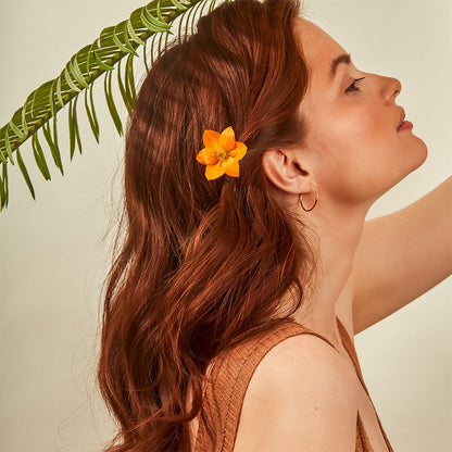 Red haired model with tropical flower in hair