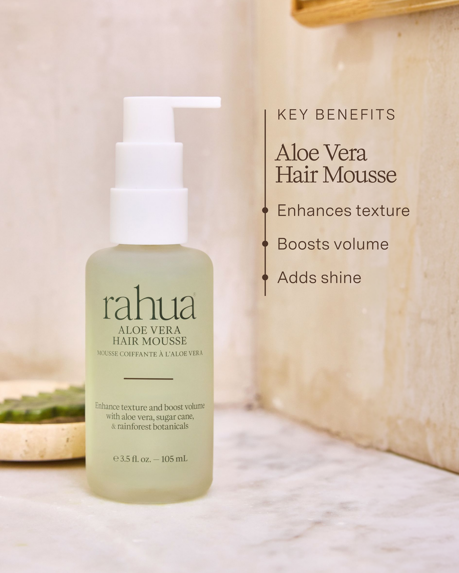 Rahua aloe vera hair mousse bottle with key benefits listed on a neutral background