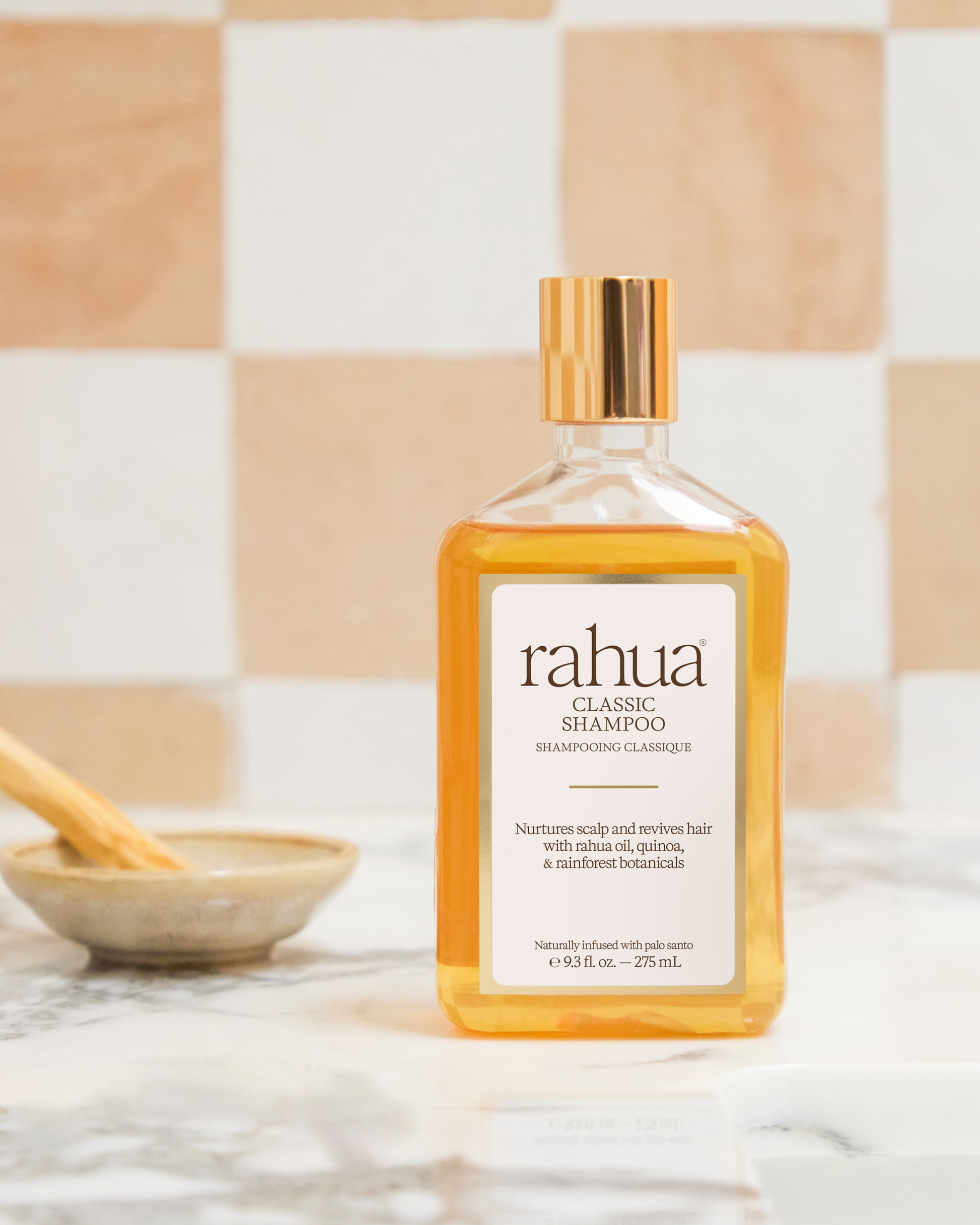 Rahua classic shampoo bottle on a bathroom counter with a checkered tile background|variant:93-oz