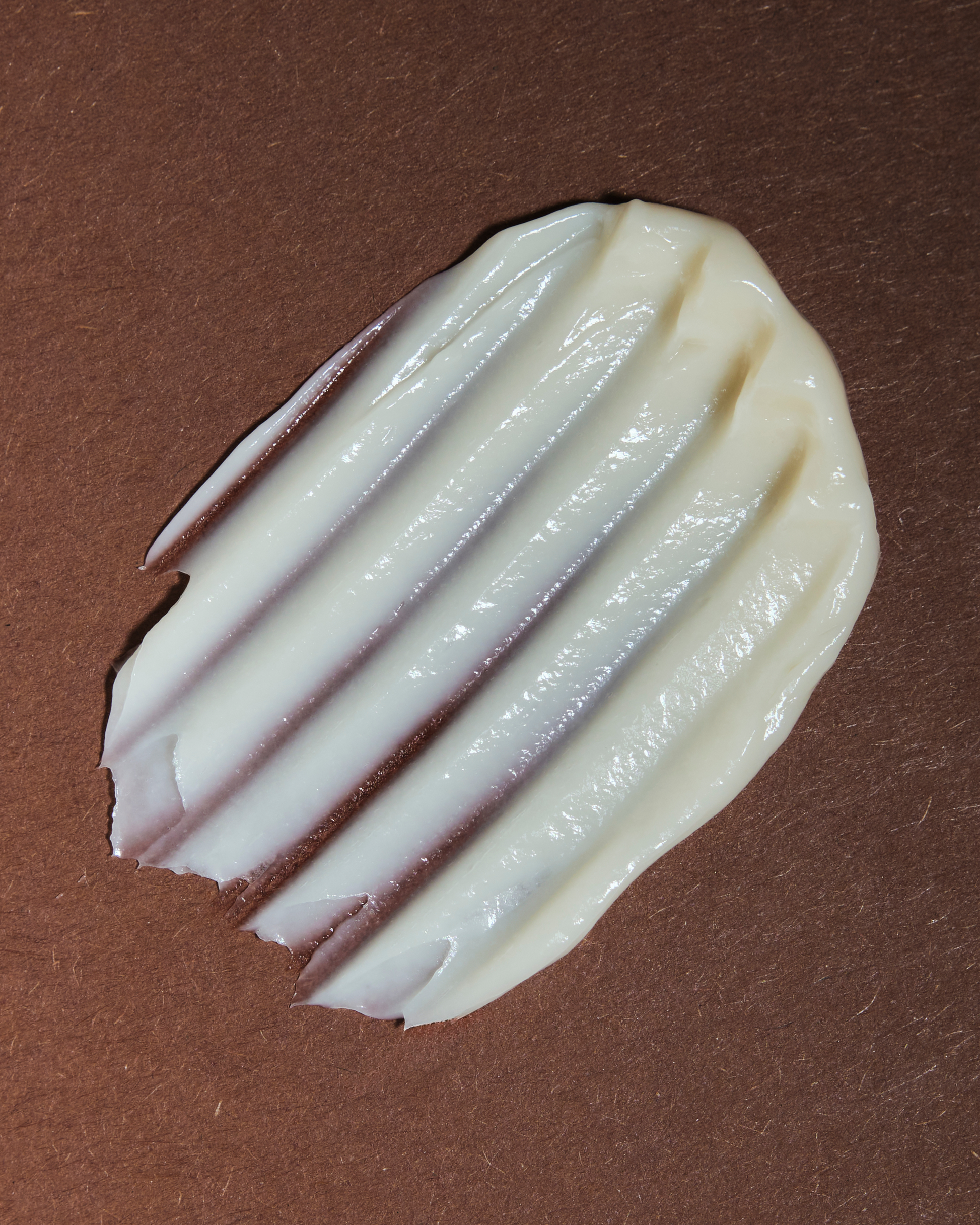 White cream swatch on a brown background