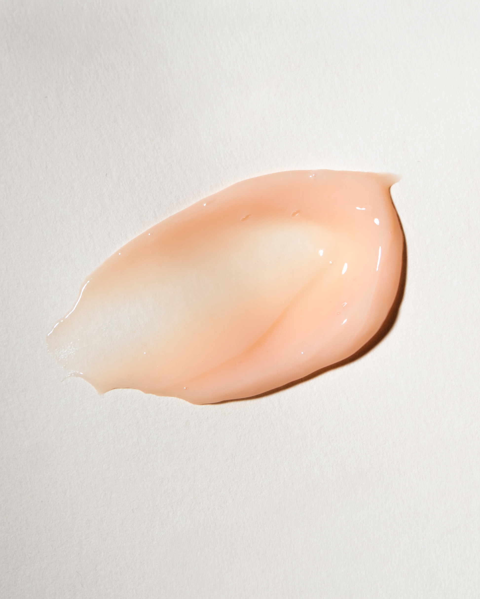 Pink cosmetic cream swatch on a light gray background|variant:93-oz,18-oz