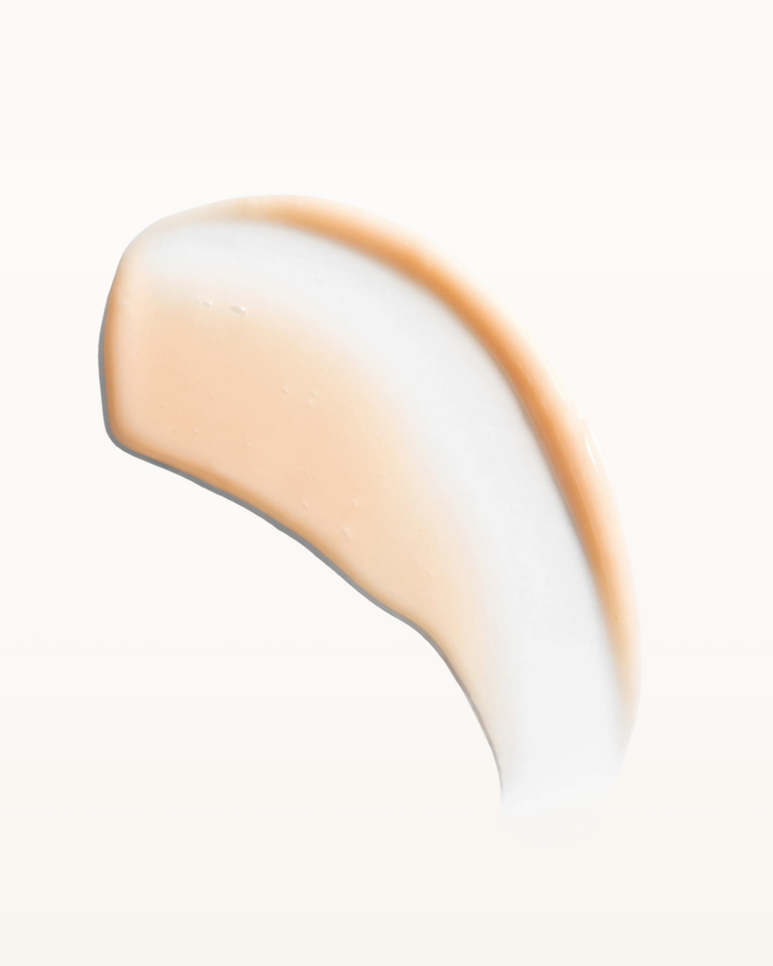 Close-up of a smooth, beige-colored conditioner on a white background, rahua enchanted island conditioner texture|variant:93-oz