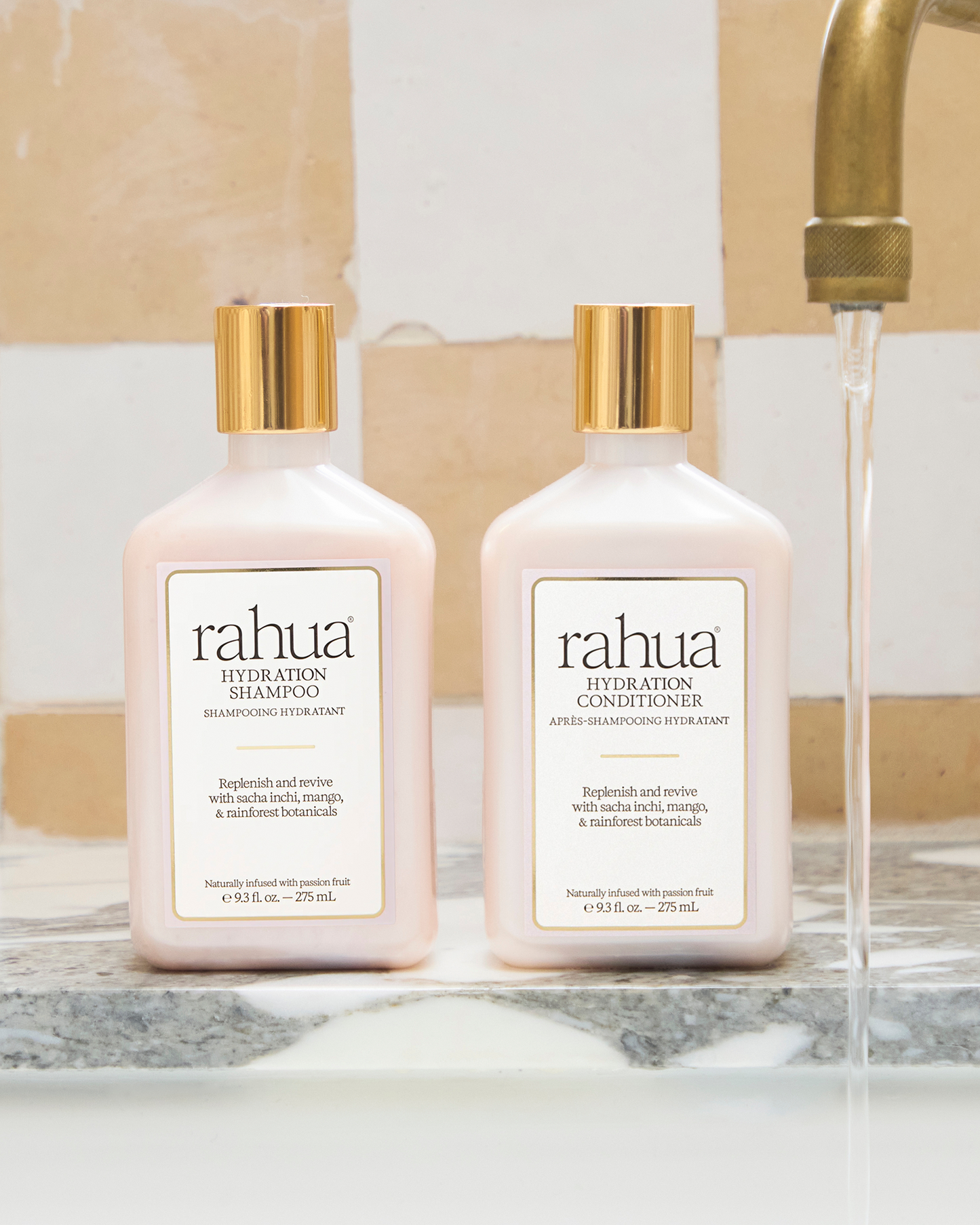 Two bottles of Rahua shampoo and conditioner on a bathroom counter.|variant:93-oz