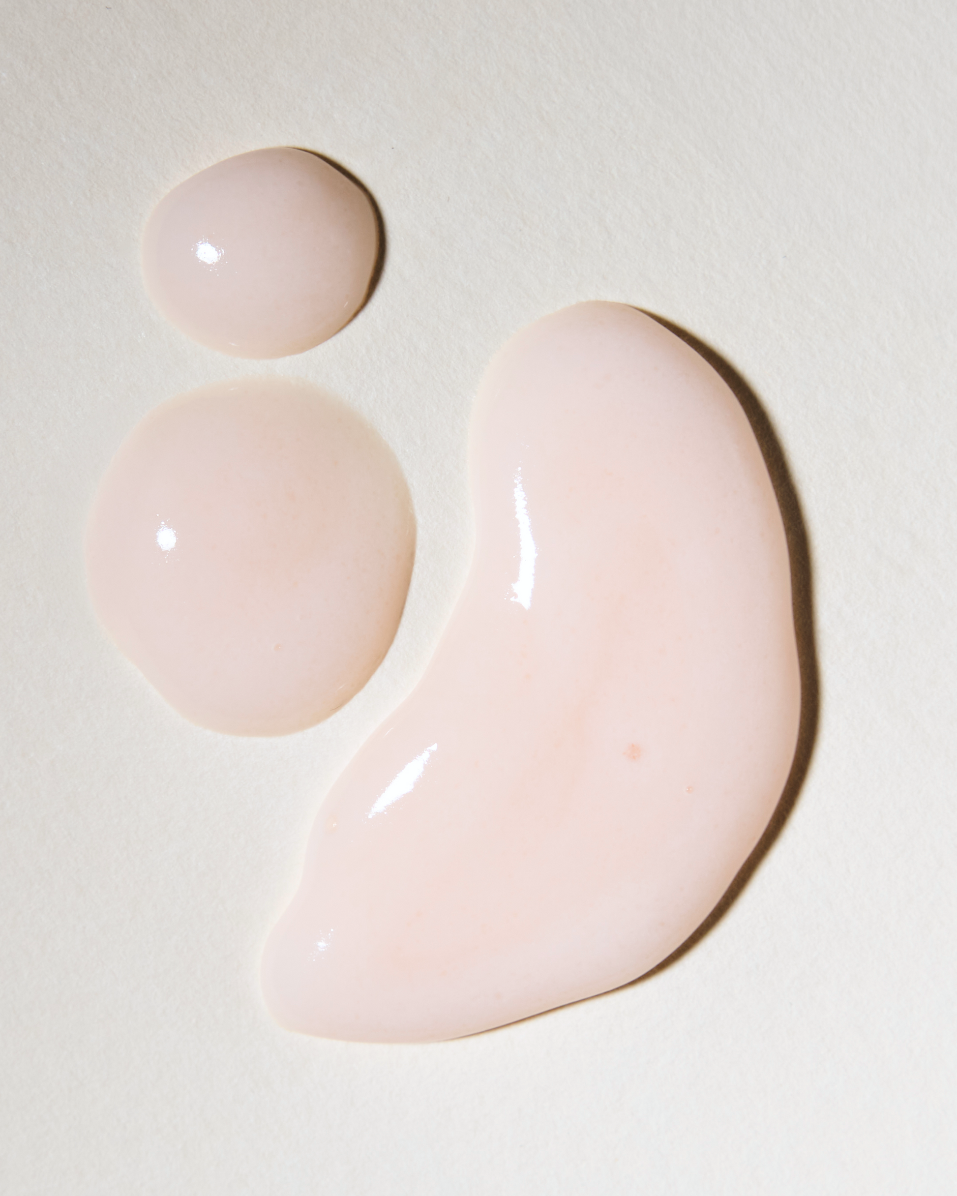 Three pink gel-like substances on a light beige background|variant:93-oz,16-oz,18-oz