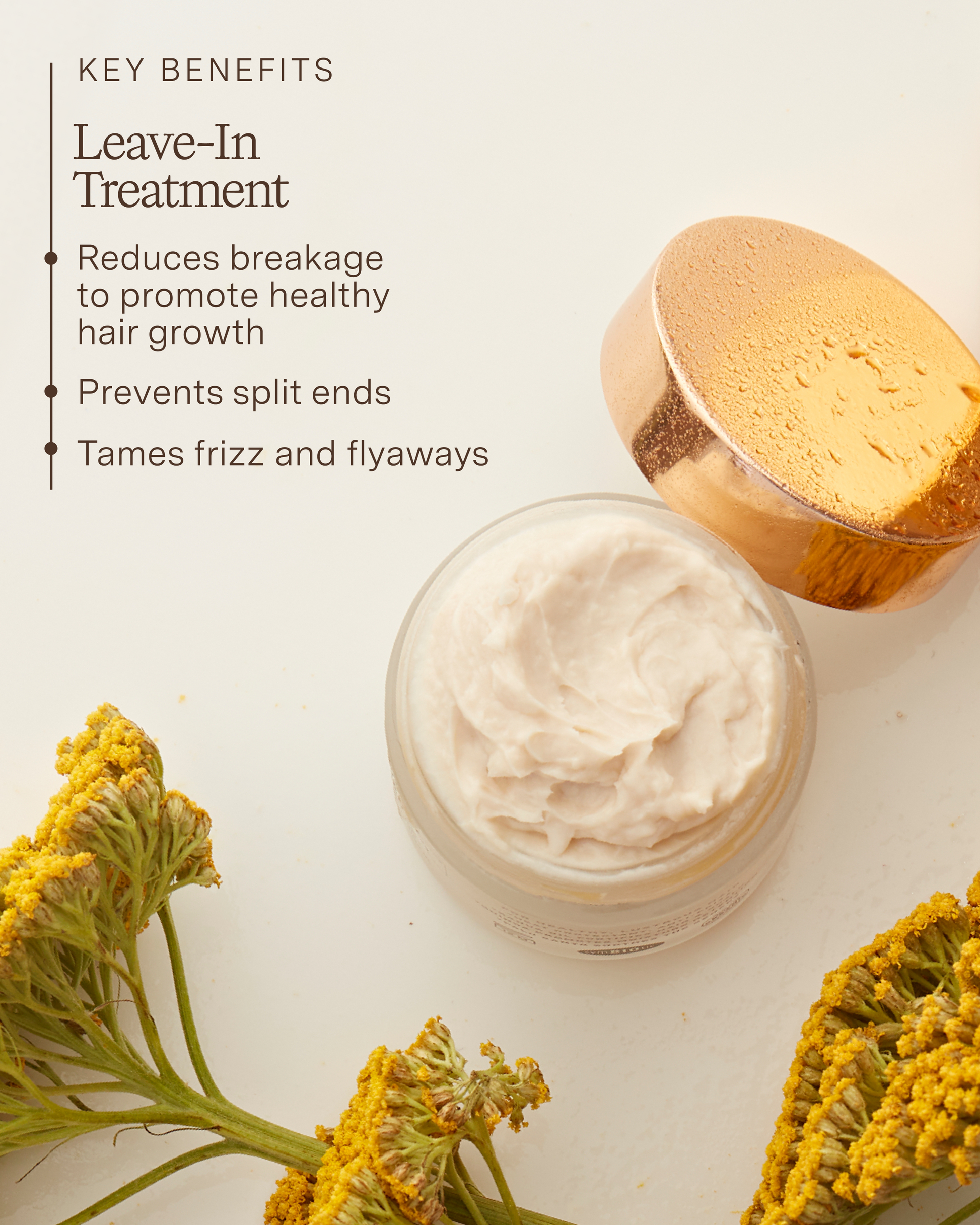 Jar of leave-in treatment cream with a wooden applicator and yellow flowers on a light background