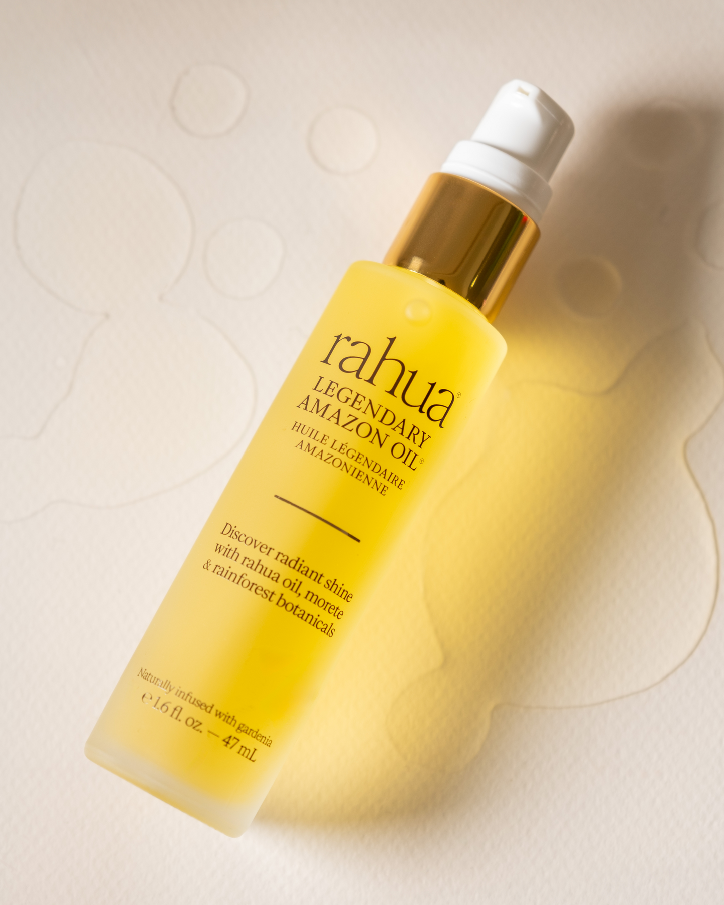 Rahua Legendary Amazon Oil bottle on a textured beige background