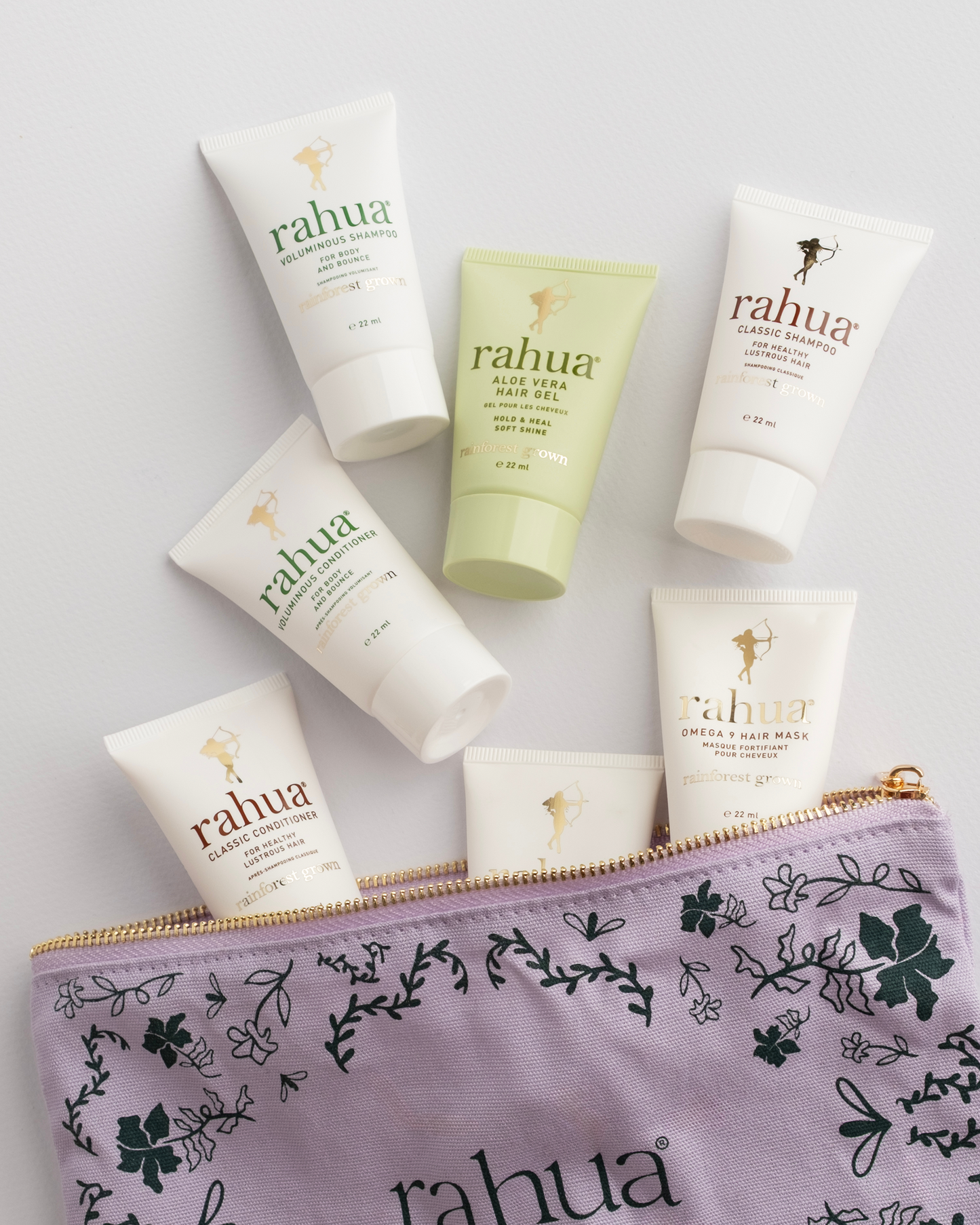 Collection of Rahua skincare products including bottles and a pouch on a light gray background