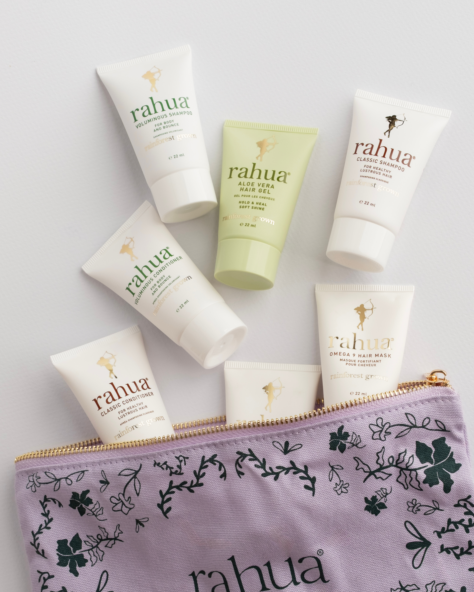 Collection of Rahua skincare products including bottles and a pouch on a light gray background