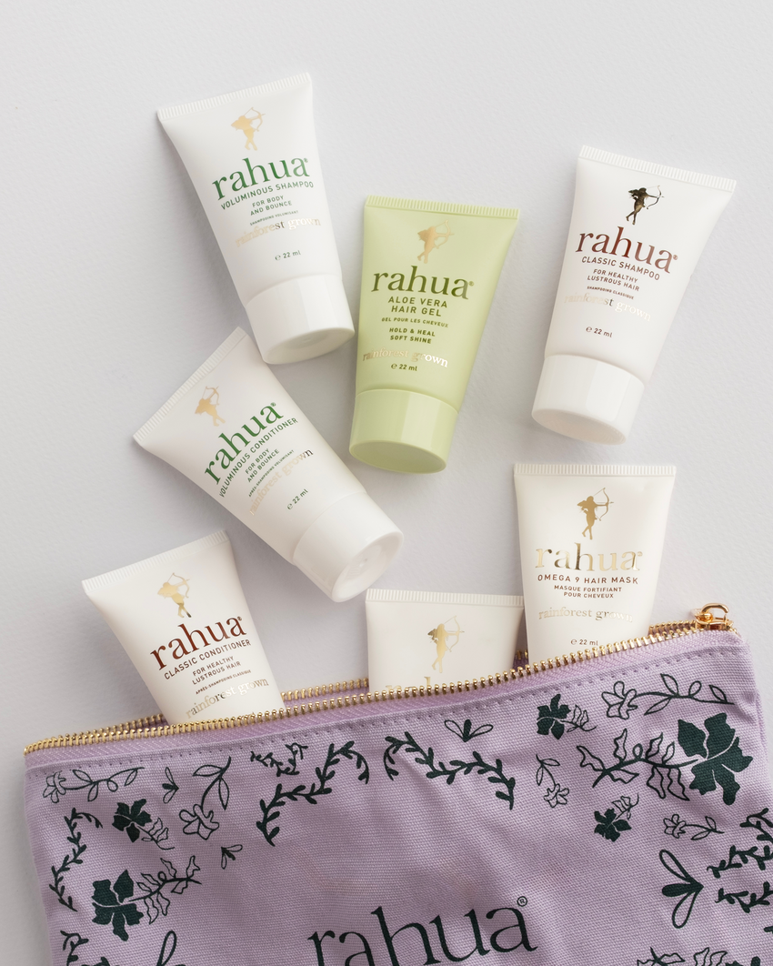 Collection of Rahua skincare products including bottles and a pouch on a light gray background