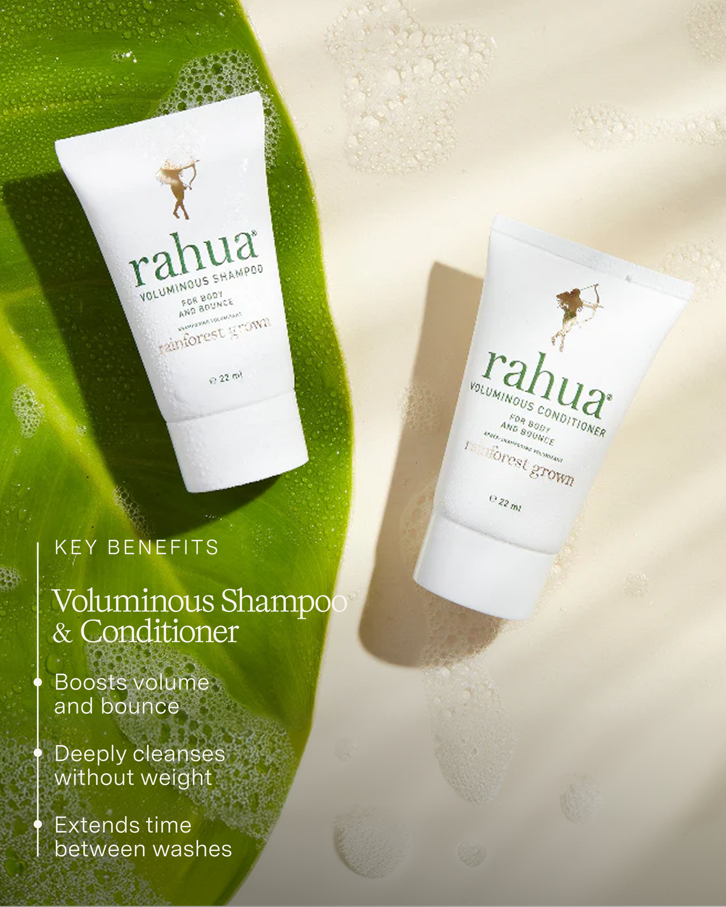 Two bottles of Rahua voluminous shampoo and conditioner on a green leaf with product details.