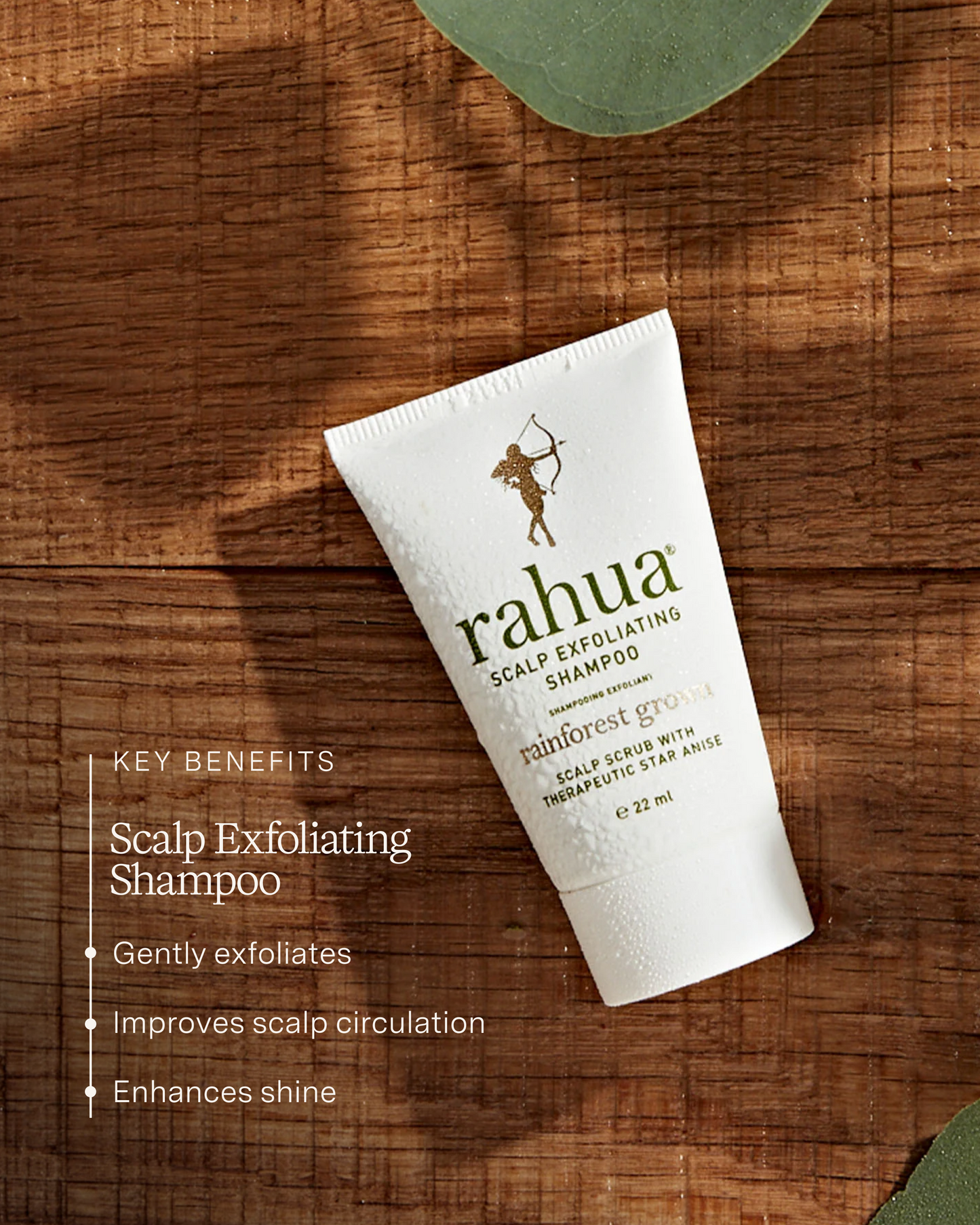 Rahua scalp exfoliating shampoo tube on a wooden surface