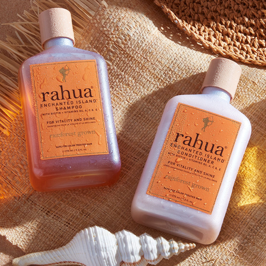 Rahua enchanted island shampoo and conditioner duo near seashell