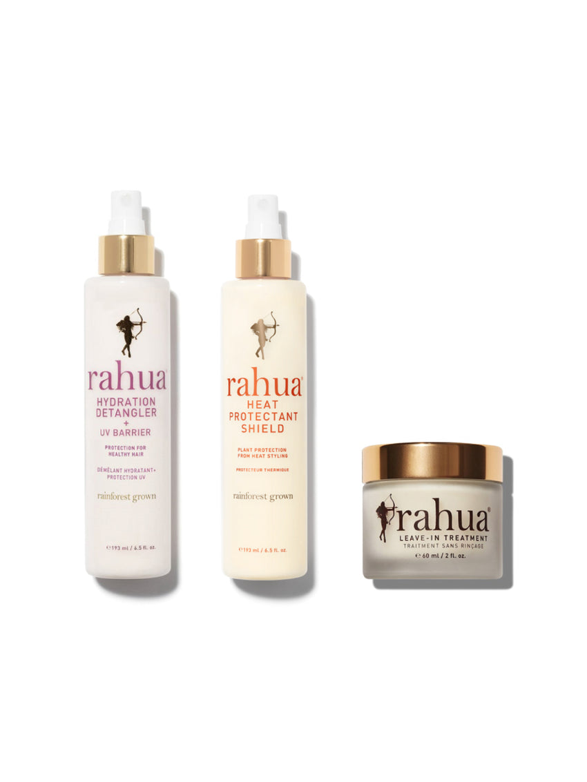 A set of three Rahua hair care products, including bottles of Hydration Detangler, UV Barrier, and Heat Protectant Shield, along with a jar of Leave-In Treatment.