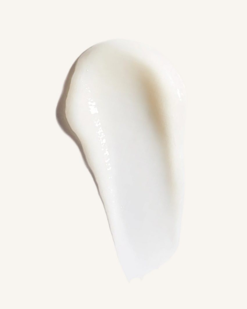 Close-up of a white swatch of voluminous conditioner on a light background|variant:93-oz