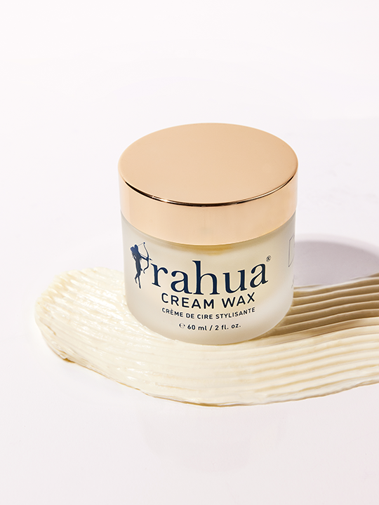 A jar of Rahua Cream Wax hair styling product against a white background with a swipe of product underneath to show texture
