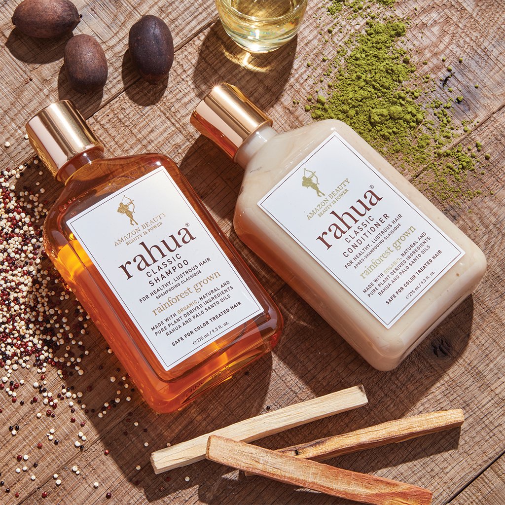 Rahua Classic Duo Set, Shampoo and Conditioner on the table with Palo Santo Sticks and Quinoa seeds