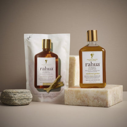 Rahua Classic shampoo refill pouch and bottle placed on marble block