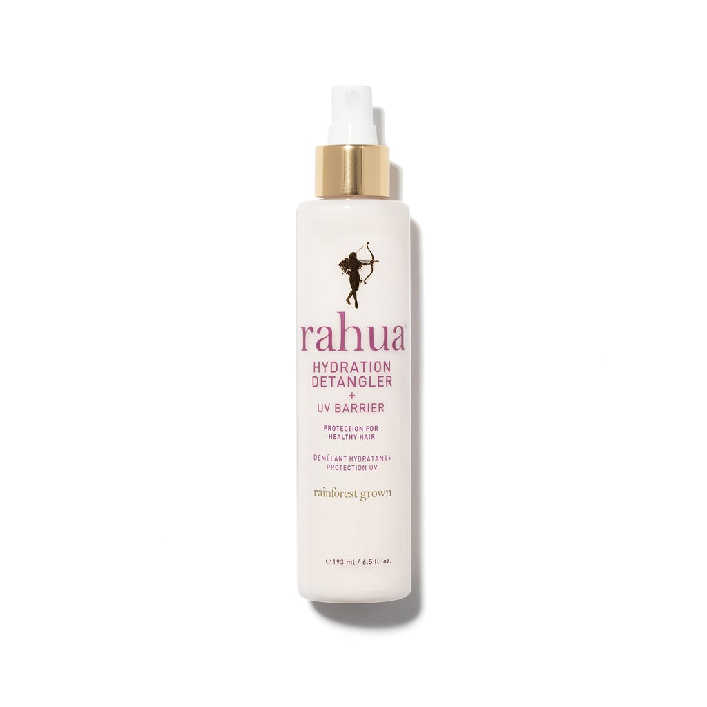 light pink spray bottle with gold collar and pink lettering rahua hydration detangler uv barrier on plain white background|variant:65-oz
