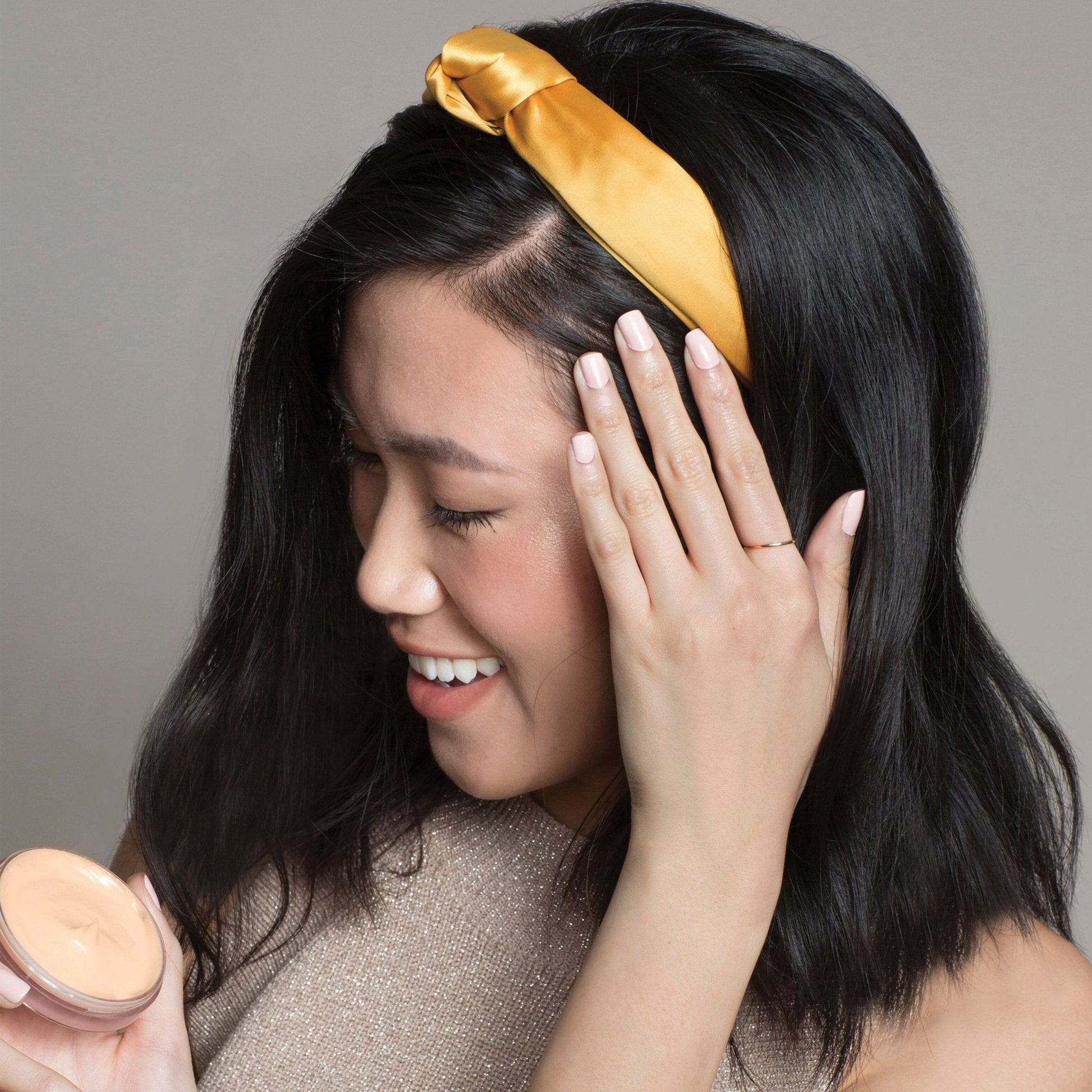 woman using smoothing hair balm for a smooth and moisturized hair