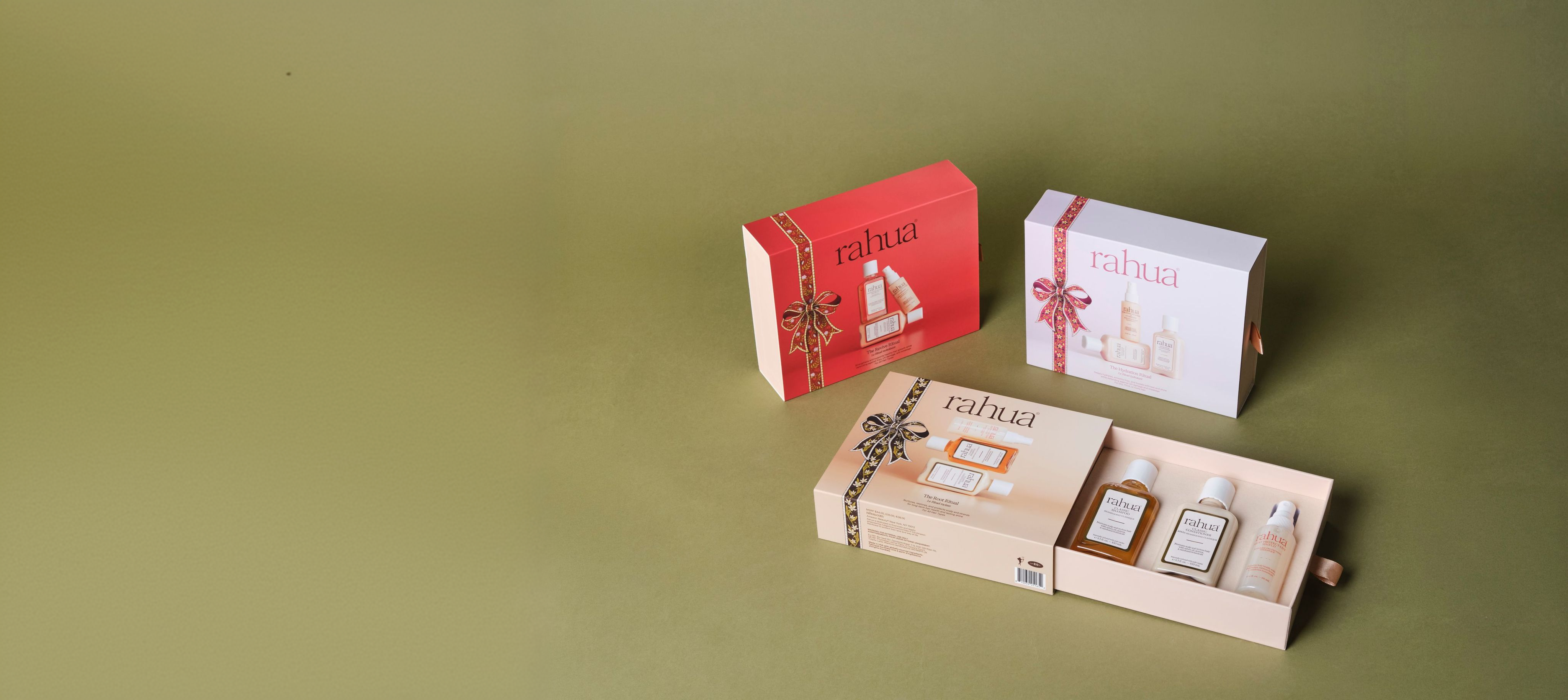 Rahua holiday ritual gift kits with an open Root Ritual box